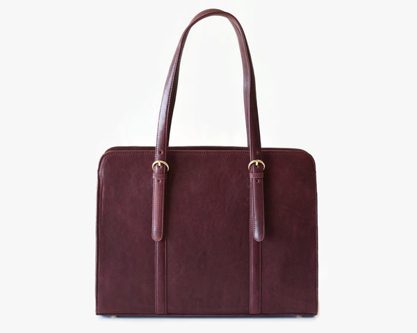 A wine-colored, full grain leather laptop bag with a shoulder strap and a zipper closure.